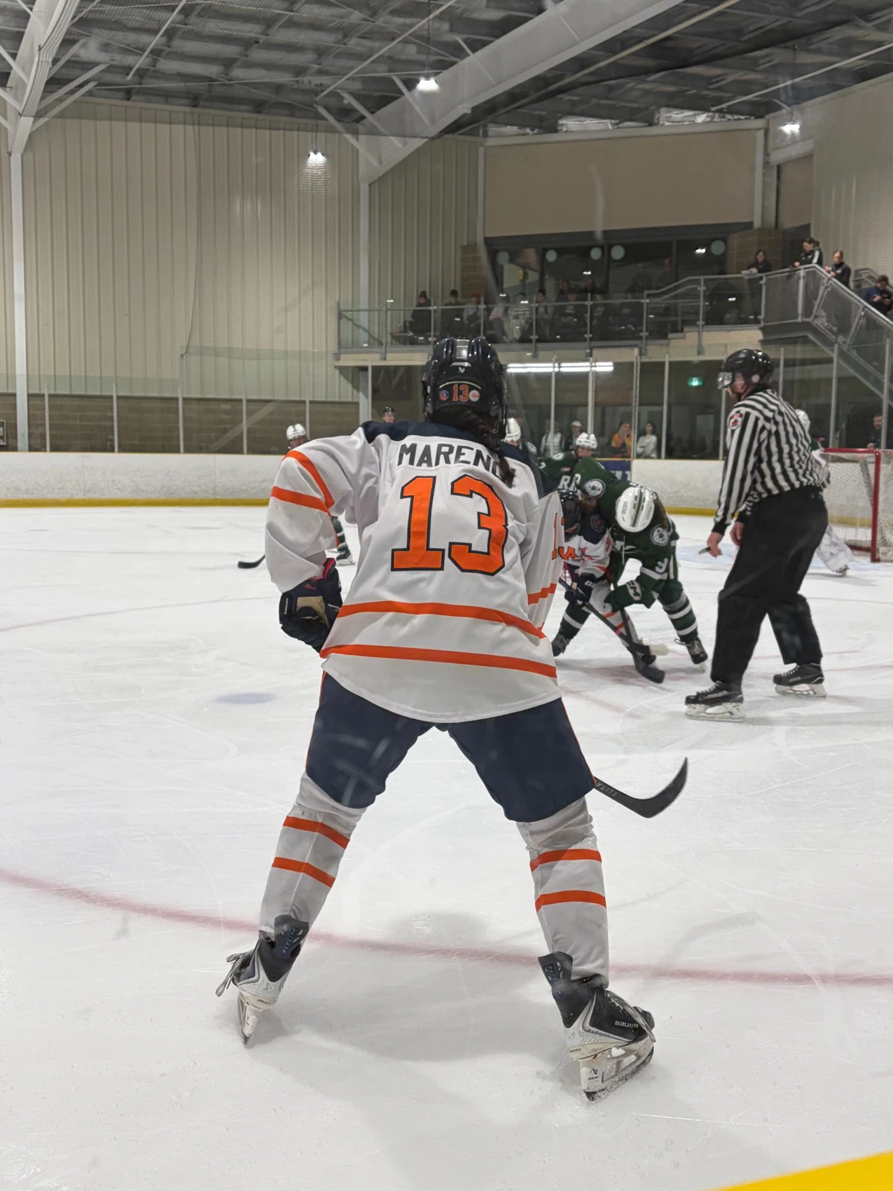 Tenley, number 13, preparing for play in her Masters uniform
